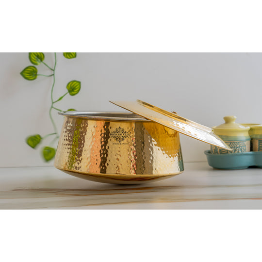 Handcrafted pital ka patila with tin lining and lid, a graceful piece of heritage cookware in golden brass