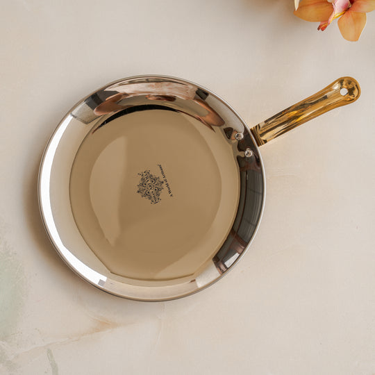 Featuring a brass handle, this steel copper hammered tawa adds a classic touch to cooking and serving from Indian Art Villa.