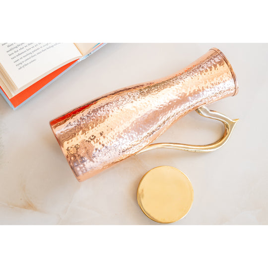 Copper jug with beautiful hammered pattern and brass lid and handle