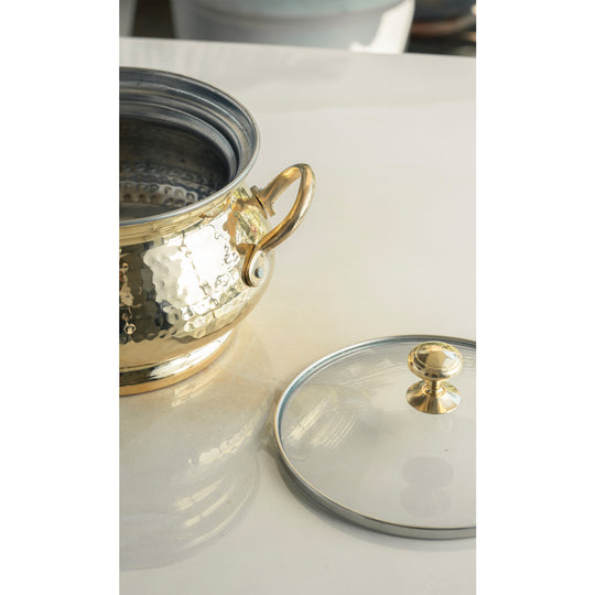 Premium hammered brass cooking pot by Indian Art Villa featuring tin lining and a glass lid with dual brass handles for authentic kitchen