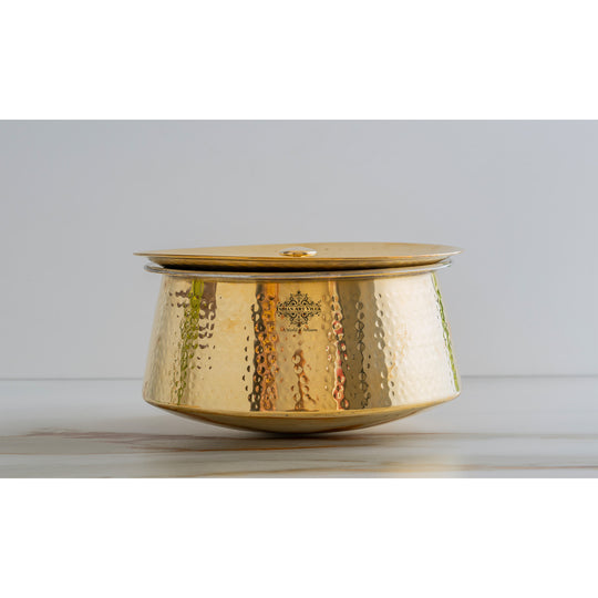 Classic brass cooking pot in hammered finish with tin interior and lid showcasing beauty and cultural heritage