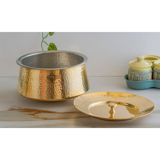 Timeless brass patila in hammered golden finish with tin interior and lid, crafted with elegance for a refined touch