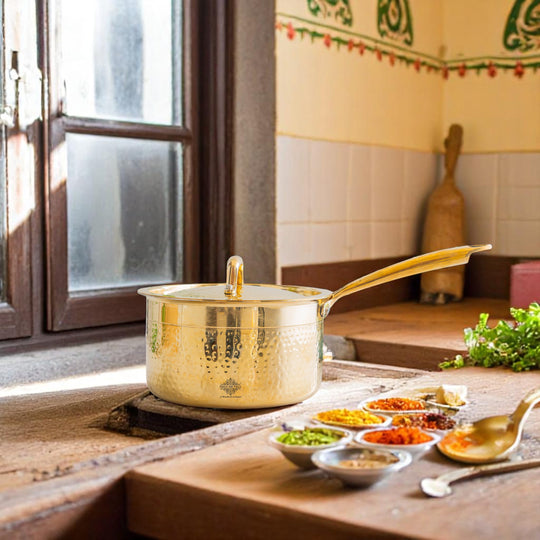 Solid brass sauce pan with hammered outer finish tin lined interior brass lid on top and single long handle fixed to vessel