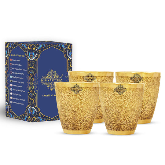 Decorative brass glass set of 4 with delicate floral carvings, ideal for serving traditional drinks with grace.