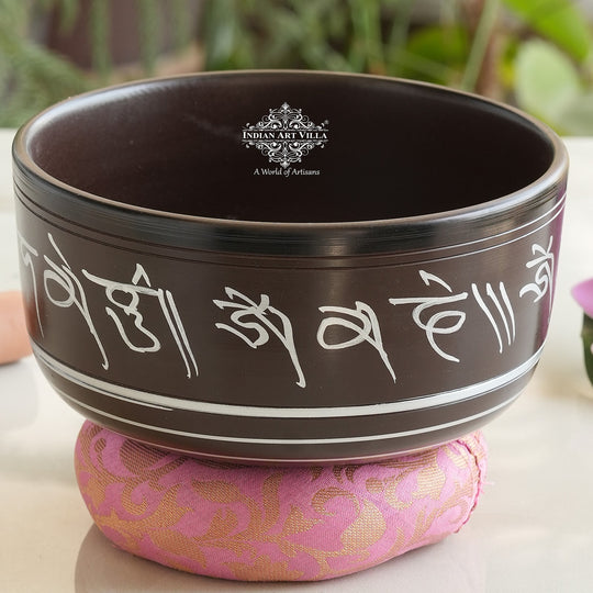 Indian Art Villa black brass singing bowl with white mantra engraving, ideal for meditation and sound healing.