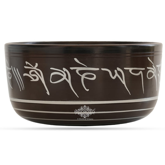 Indian Art Villa black brass singing bowl with white mantra engraving, ideal for meditation and sound healing.