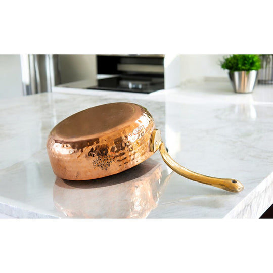 Indian Art Villa copper round pan with tin lining and brass handle enhances your cooking experience beautifully.