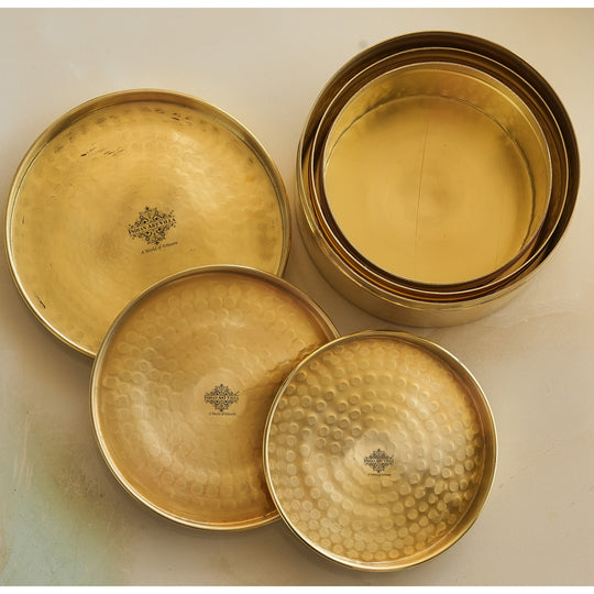 Golden brass storage box set featuring sculpted hammered covers smooth round base and timeless artisan form