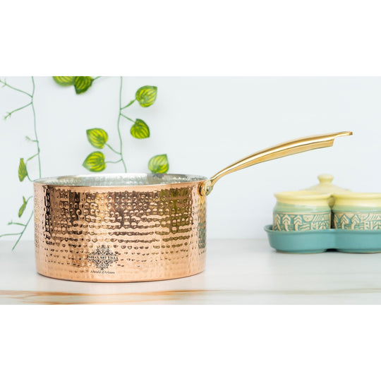 Copper saucepan with a hammered design and steel body, offering both aesthetics and practicality.
