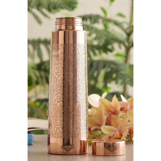 A classic 900ML pure copper bottle by Indian Art Villa, pyramid-shaped and detailed with exquisite embossed artwork