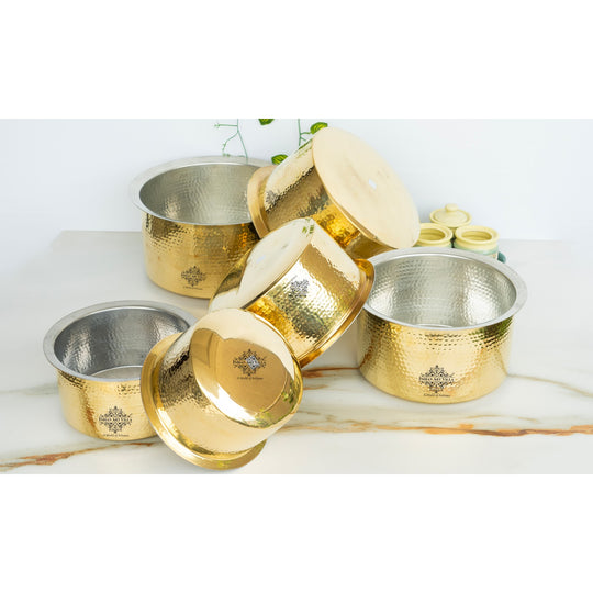 Brass patila featuring polished golden shine hammered design round body fitted lid and silver tin coated interior