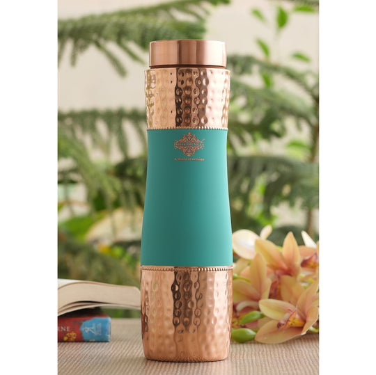 Turquoise silk and hammered copper bottle meet in Indian Art Villa bottle designed for refined hydration with an artisan touch.