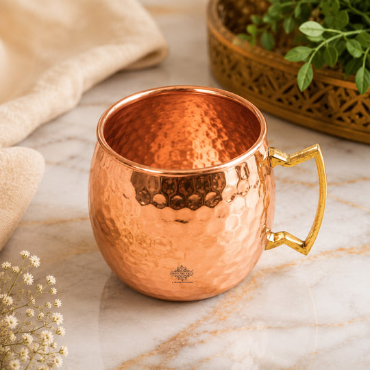 Handcrafted copper mug featuring a reflective hammered surface