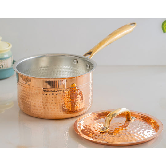 Ayurvedic style hammered copper pan with brass handle and safe inner coating to enhance wellness in daily meals