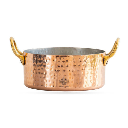 With golden handles and a hammered finish, this copper pot by Indian Art Villa is ideal for cooking and serving.