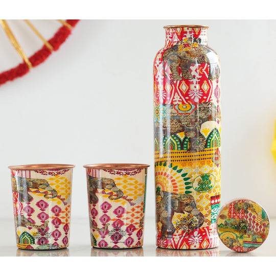 Indian Art Villa's Copper Bottle & Glass Set adorned with Rajasthani Meena 'Padharo Mhare Desh' and Ayurvedic Drinkware, featuring Pagdi Art.