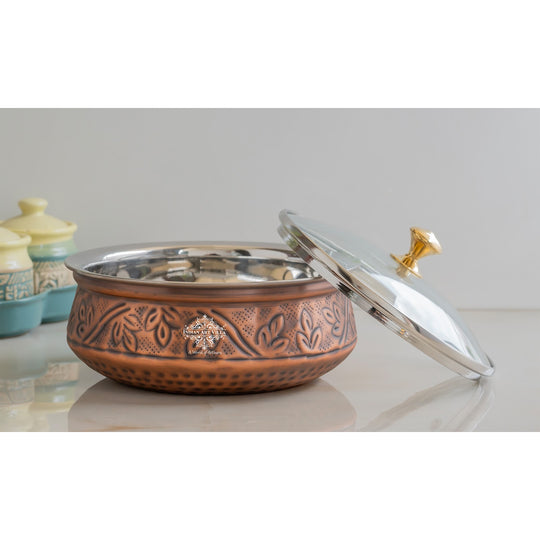 The essence of tradition captured in Indian Art Villa copper handi featuring intricate patterns and graceful glass lid