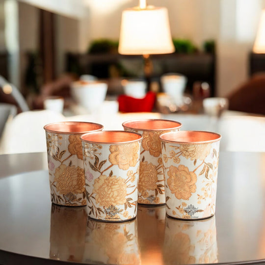 Vibrant gold prints decorate the copper glass for drinking water in this Indian Art Villa set of 4