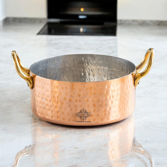 Gorgeous hammered copper handi from Indian Art Villa with brass handles, perfect for a traditional touch in modern kitchens.