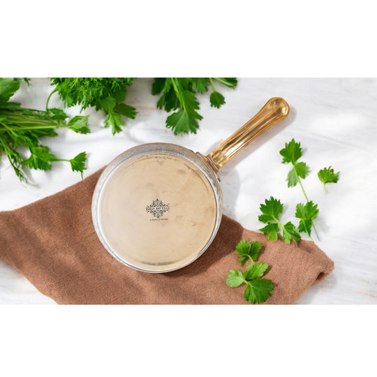 Premium copper cookware with a polished interior and durable brass handle, a timeless kitchen essential.