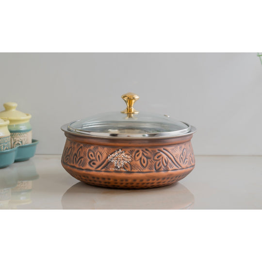 Handcrafted copper handi from Indian Art Villa featuring antique finish delicate embossing and a radiant glass lid