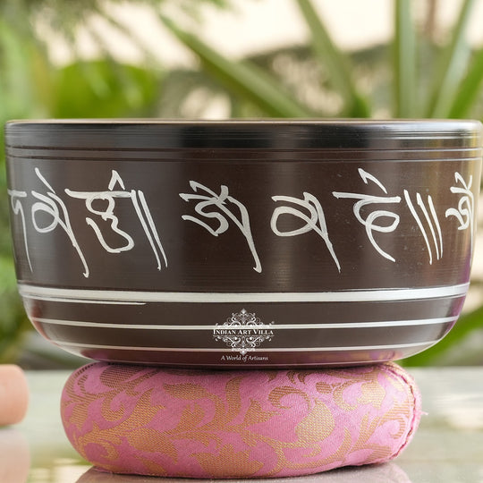 Indian Art Villa black brass singing bowl with white mantra engraving, ideal for meditation and sound healing.