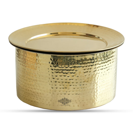 Elegant hammered brass patila design featuring lustrous golden polish dome style lid rounded base and silver tin lining