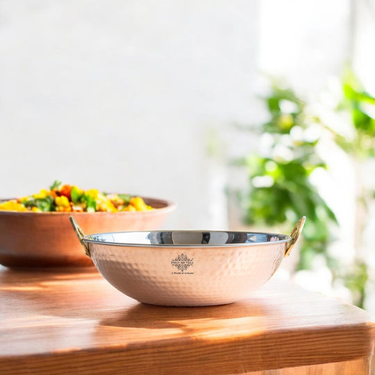 Steel copper hammered kadhai serving hot Indian curry