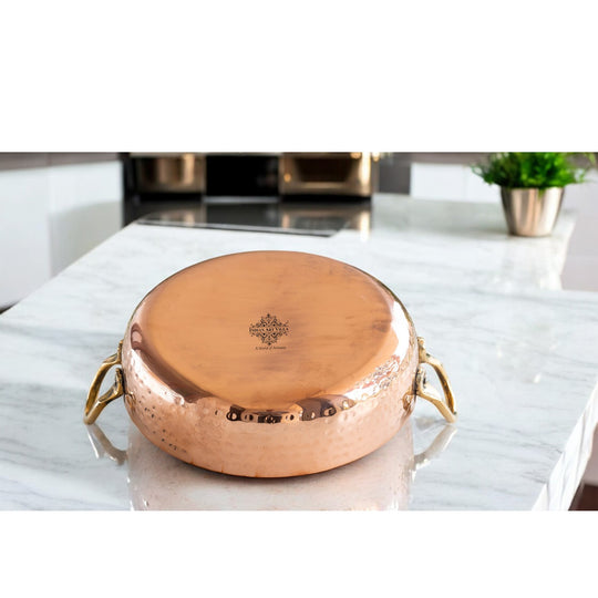 Stylish copper pan with kalai lining and brass handles, a classic addition to your kitchen for efficient cooking