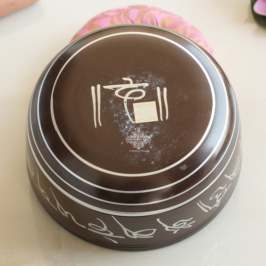 Indian Art Villa black brass singing bowl with white mantra engraving, ideal for meditation and sound healing.