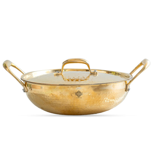 Hammered pital kadhai with polished golden surface tin lining lid and durable handles designed for traditional Indian cooking