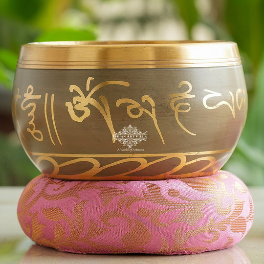 Indian Art Villa brass singing bowl with golden mantra design and cushion, ideal for meditation, sound therapy, and gifting.