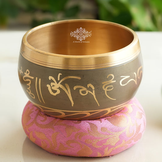 Indian Art Villa brass singing bowl with golden mantra design and cushion, ideal for meditation, sound therapy, and gifting.