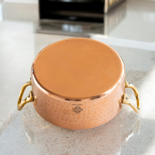 Indian Art Villa’s hammered copper cookware with brass handles offering both utility and decorative charm.