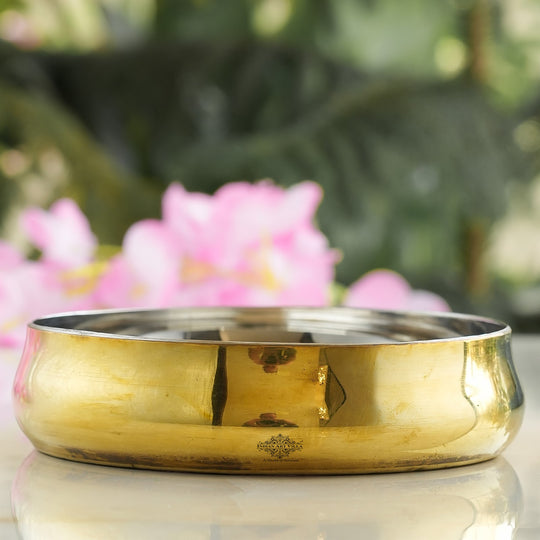 Steel brass rice plate with handcrafted curved design seamless joint structure and smooth shiny golden metal body