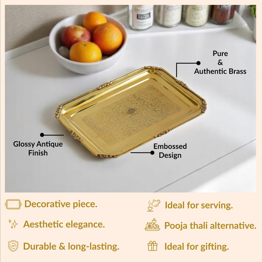 Sculpted brass tray from Indian Art Villa in rectangular form featuring intricate floral border and embossed center