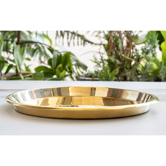 Elegant brass thali with smooth plain design wide surface area and finely crafted raised rim in polished brass finish