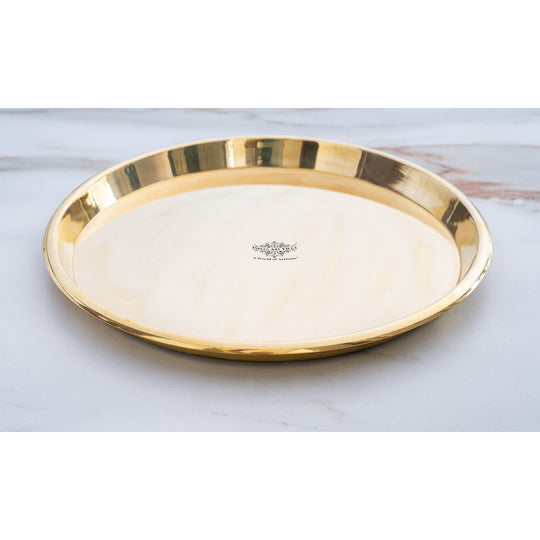 Indian Art Villa presents a plain brass thali with smooth polished finish broad flat base and delicately curved edge