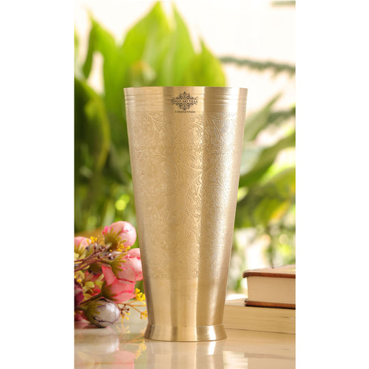 Indian Art Villa brass lassi glass with intricate embossed flower design and 400ml capacity for serving drinks.