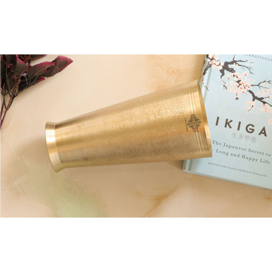 Brass lassi glass with embossed floral detailing and 400ml capacity from Indian Art Villa for traditional use.
