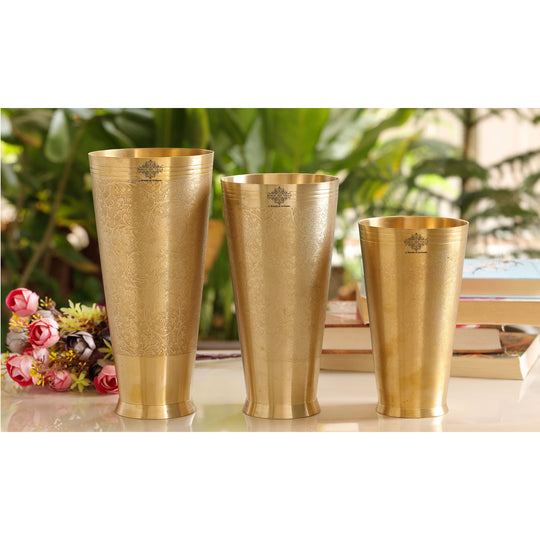 Decorative brass lassi glass with embossed flower design and 400ml capacity ideal for serving beverages.