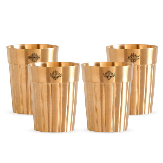 Set of 4 pure brass glasses with a refined lined finish, perfect for serving drinks with a traditional touch.