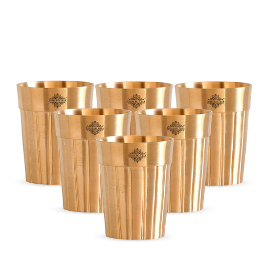 Premium pure brass glass with smooth lined texture perfect for serving drinks with an artistic and modern flair.