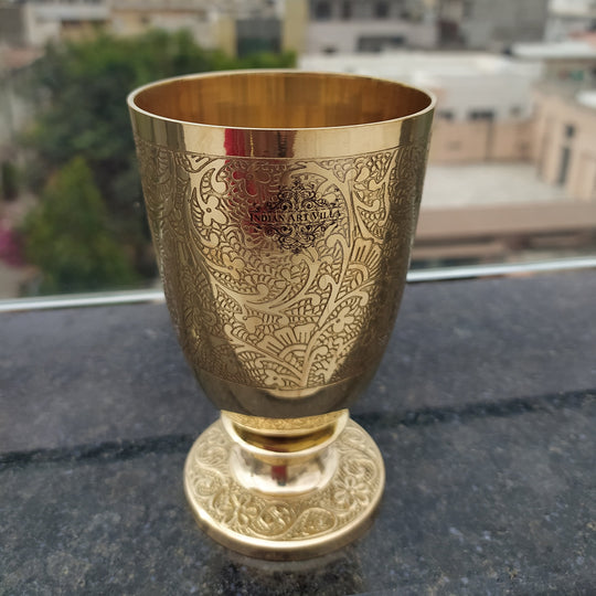 Brass glass with flower embossed design used in spiritual rituals wellness practices and as luxury drinkware for dining