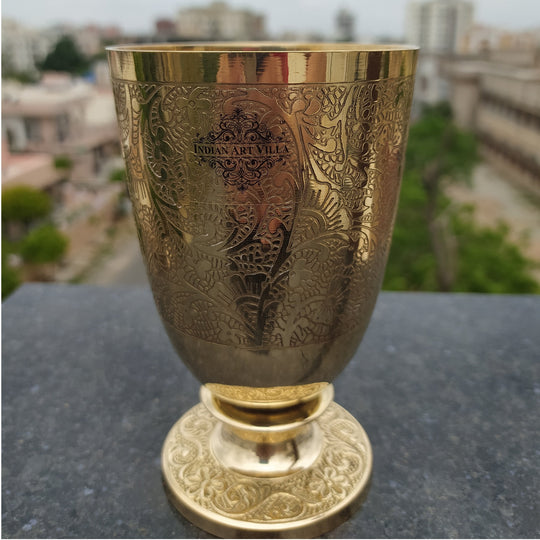 Elegant brass glass with flower embossed design ideal for gifting on weddings housewarmings or traditional celebrations
