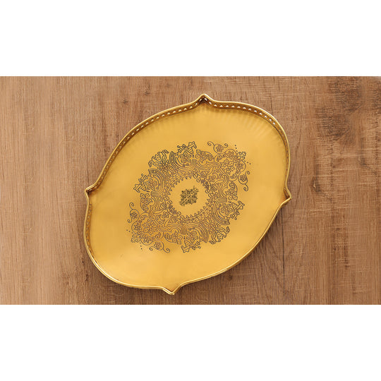 Decorative brass platter in matt finish crafted in oval form with detailed embossed center and scalloped frame edges