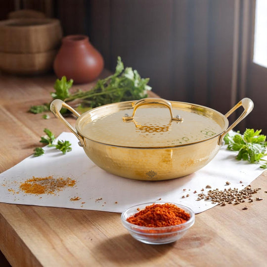 Exquisite brass cookware hammered golden body tin lining and a matching lid with handles for authentic Indian dining