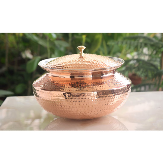 Elegant pure copper handi from Indian Art Villa with hammered detailing and brass lid, ideal for home or restaurant use.