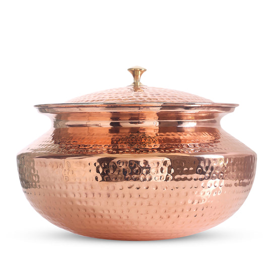 Exquisite hand-hammered copper handi with an elegant brass lid, designed for both traditional cooking and decorative presentation.