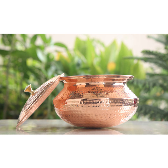 Copper handi with a polished brass lid and a beautifully hammered exterior, ideal for traditional cooking and meal presentation.